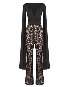 BLACK CAPE SLEEVE JUMPSUIT WITH SEQUIN TROUSER AND CONTRAST NUDE LINING