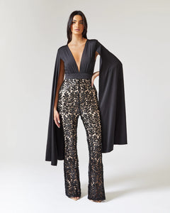 BLACK CAPE SLEEVE JUMPSUIT WITH SEQUIN TROUSER AND CONTRAST NUDE LINING