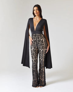 BLACK CAPE SLEEVE JUMPSUIT WITH SEQUIN TROUSER AND CONTRAST NUDE LINING