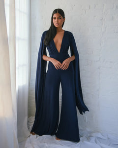 NAVY JERSEY WIDE LEG JUMPSUIT WITH CAPE SLEEVE AND OPEN BACK