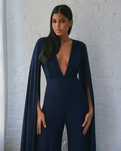 NAVY JERSEY WIDE LEG JUMPSUIT WITH CAPE SLEEVE AND OPEN BACK